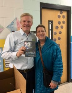 Vericom CEO Blake Philips delivering dictionaries with Laura Brockman.